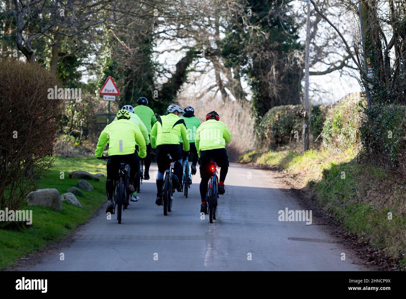 A group of cyclists in Barston village, West Midlands, England, UK Stock Photo