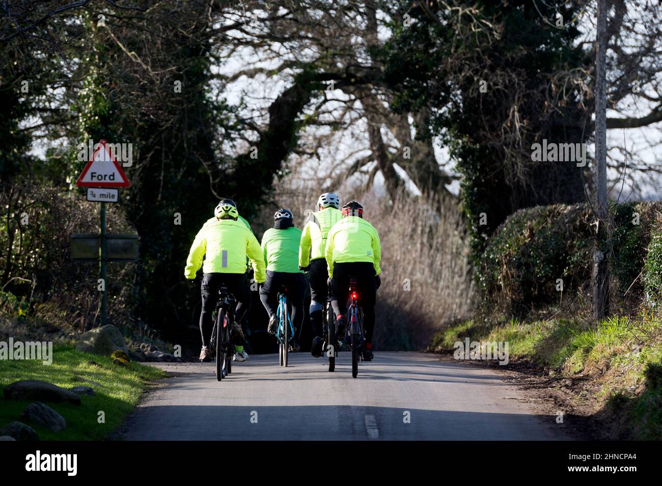 A group of cyclists in Barston village, West Midlands, England, UK Stock Photo