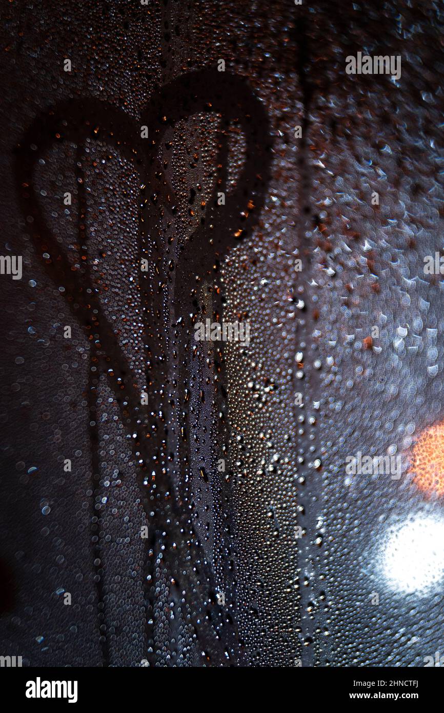 City view through a window on a rainy night,Rain drops on window with ...