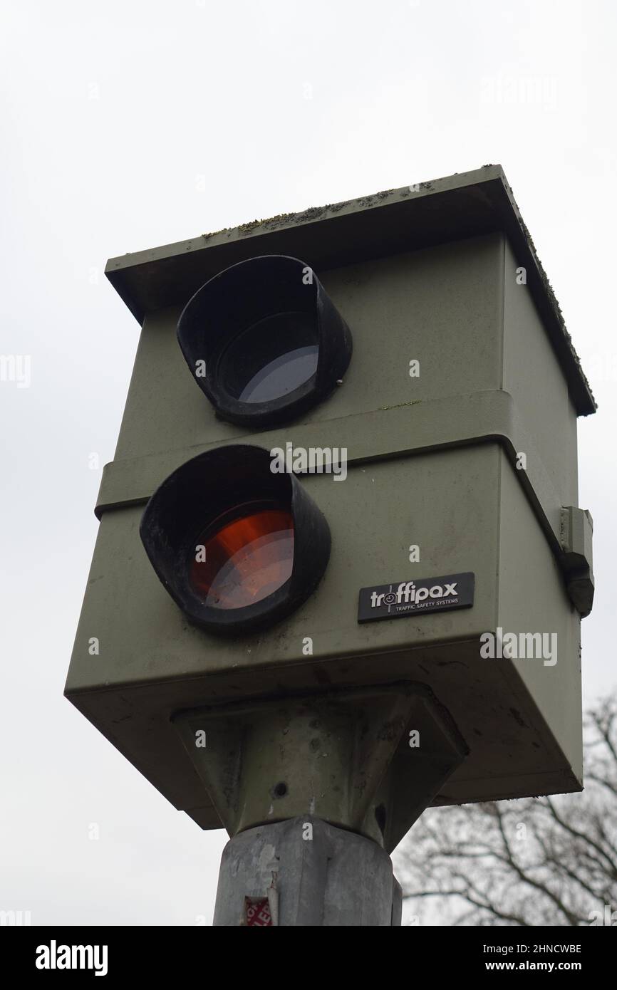 24 January 2022, Kaiserslautern, Germany, Box shaped stationary dark green traffipax speed trap (slang 'Starenkasten', starling's nest box) (vertical) Stock Photo