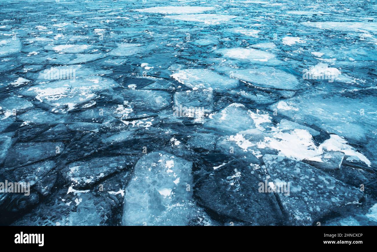 Blue uneven ice on the lake, abstract natural background. Stock Photo