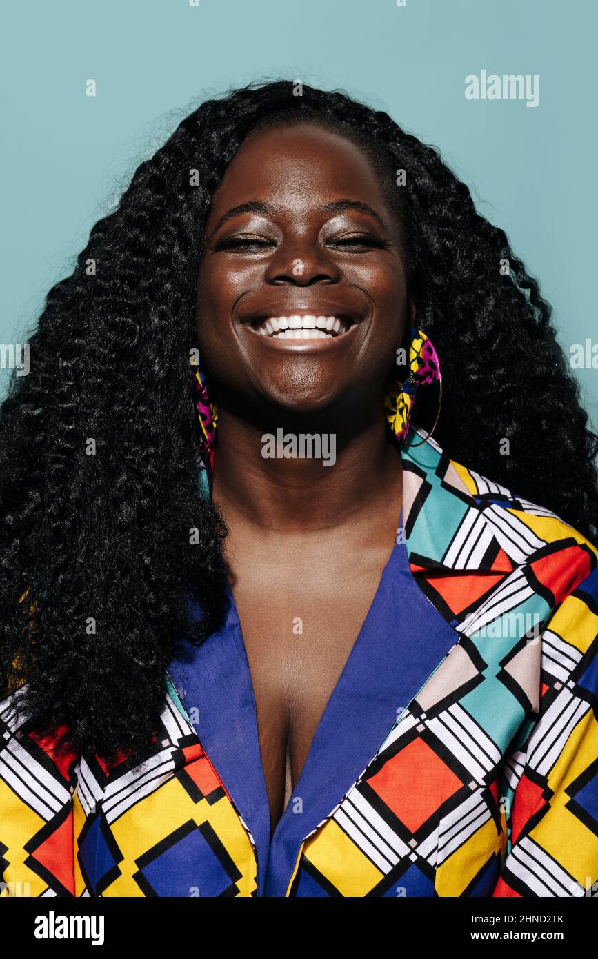 Happy African American Woman with curly hair smiling and eyes closed ...