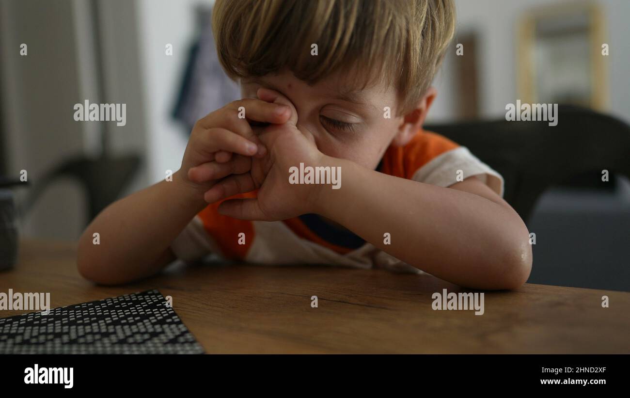 Child rubbing face and nose with hands Stock Photo Alamy