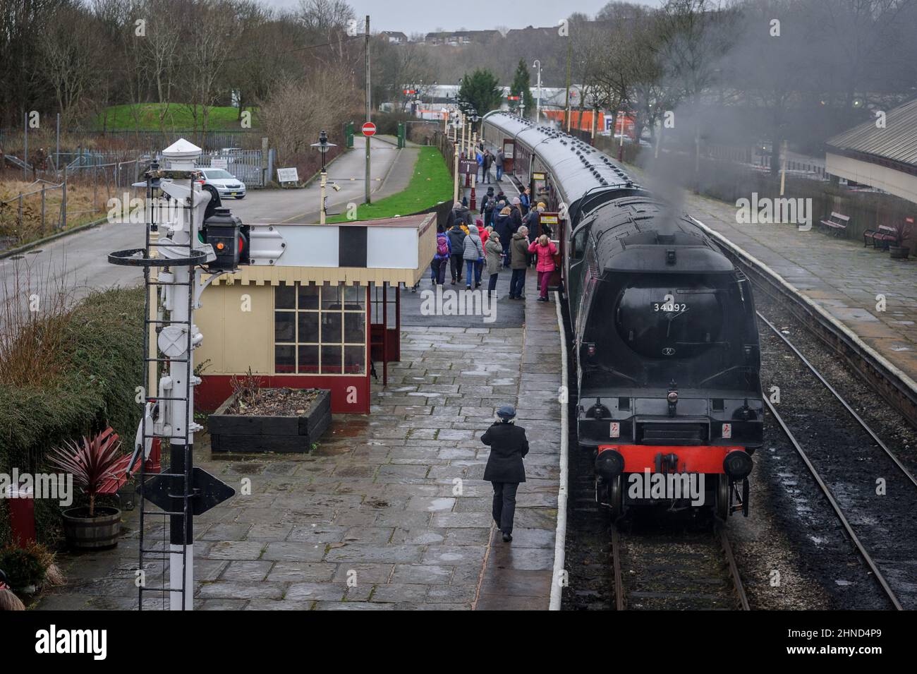 Ramsbottom, Lancashire, UK, Wednesday February 16, 2022. The City of Wells engine pulls into Ramsbottom Station to pick up passengers on a wet afternoon in Lancashire. The service is part of the volunteer run East Lancashire Railway's half term programme of events. Credit: Paul Heyes/Alamy News Live Stock Photo