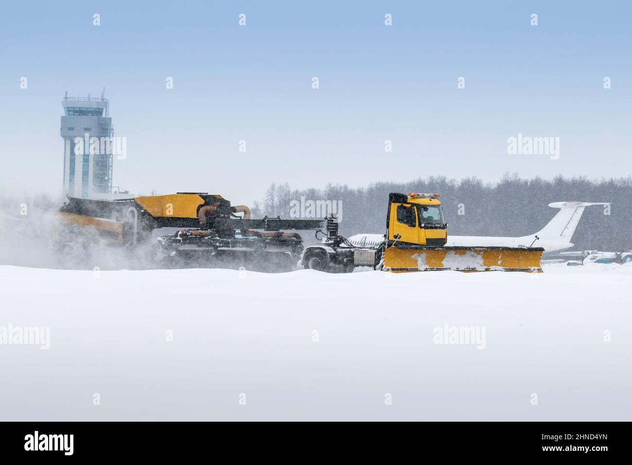 Airfield snow removal truck cleaning the runway at the airport in a