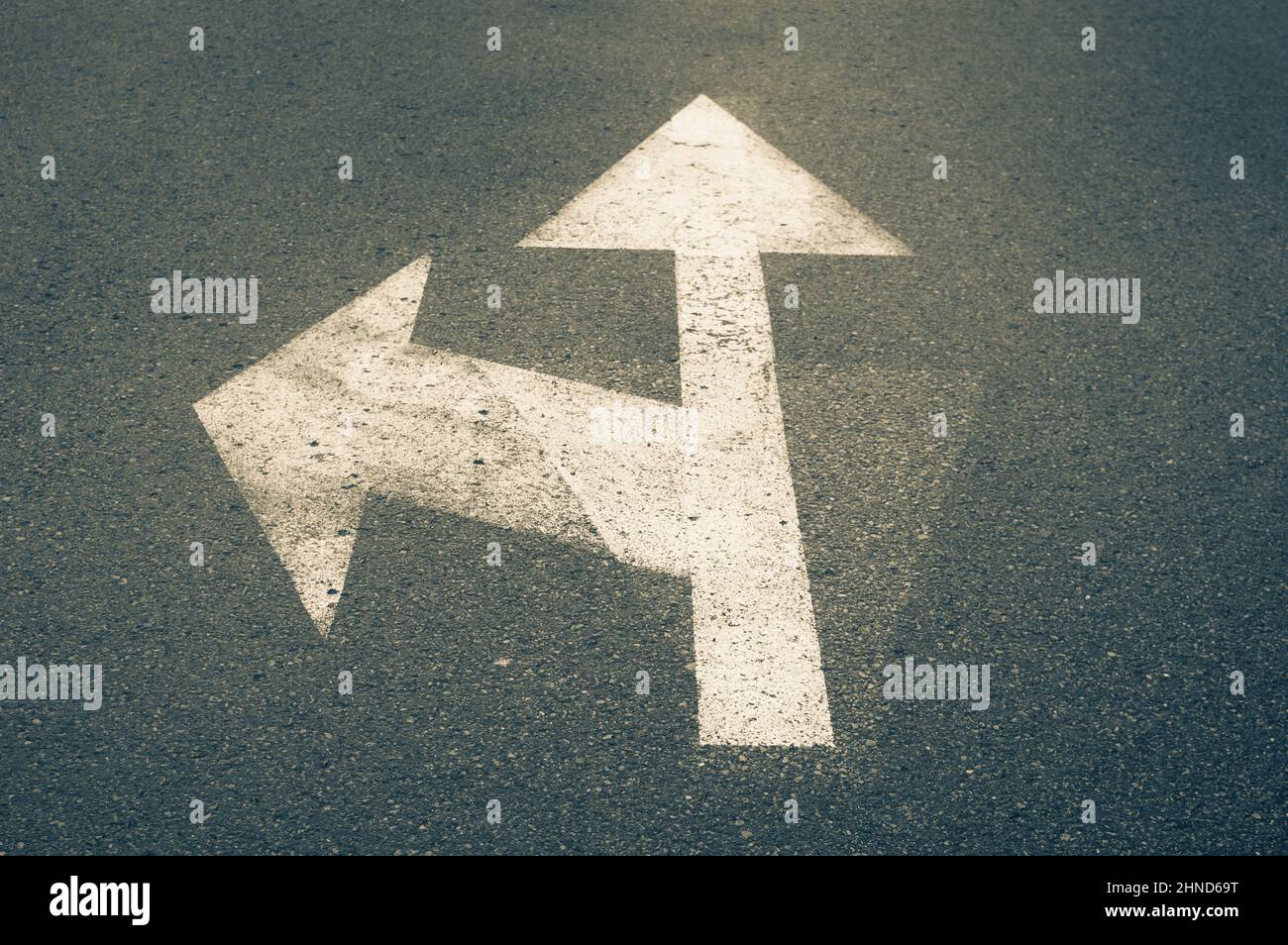 Direction sign on asphalt showing allowed directions - turn left and go straight Stock Photo