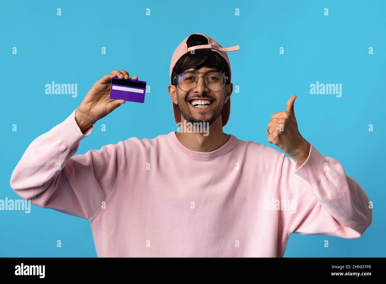 Cheerful indian man showing credit card and thumb up Stock Photo - Alamy