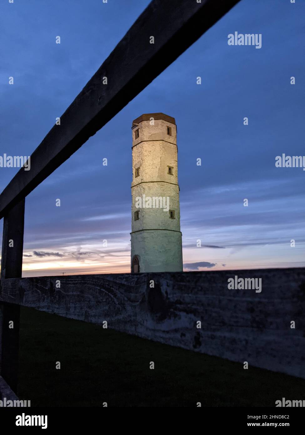 The old lighthouse at Flamborough head, North Yorkshire, lit up by the new lighthouse beam of light Stock Photo