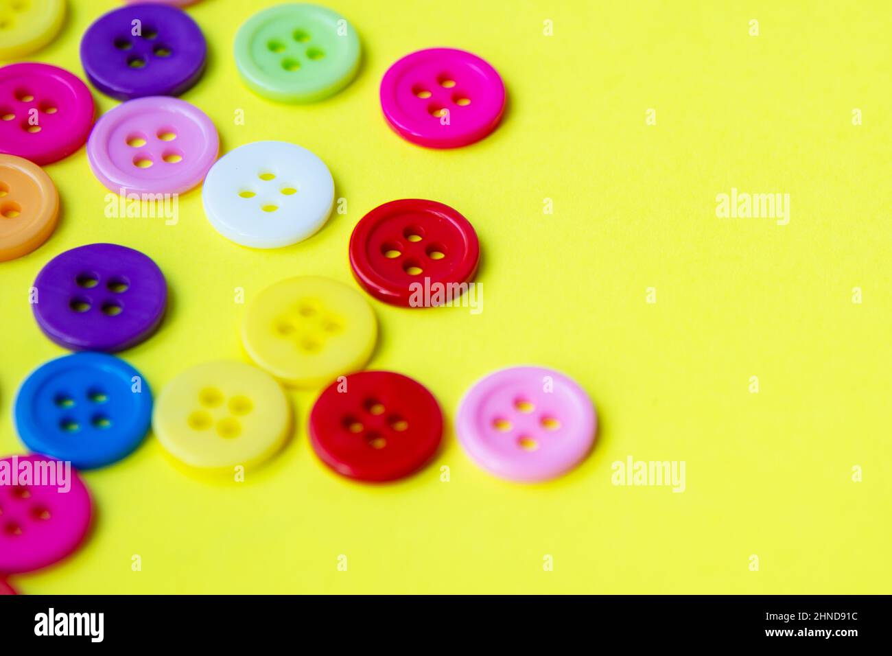 Cloth buttons on the yellow background with copyspace Stock Photo - Alamy