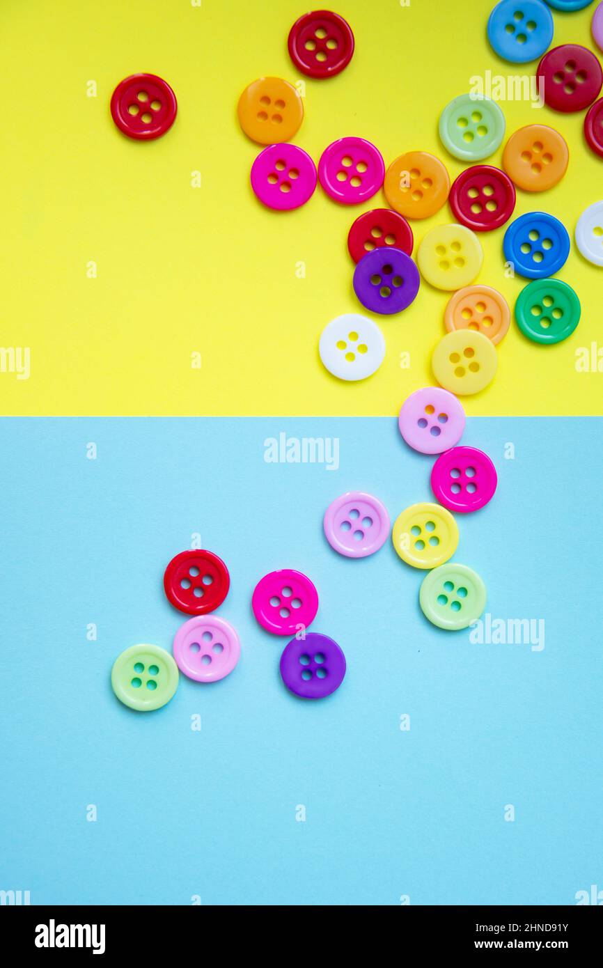 Cloth buttons on the yellow background with copyspace Stock Photo - Alamy