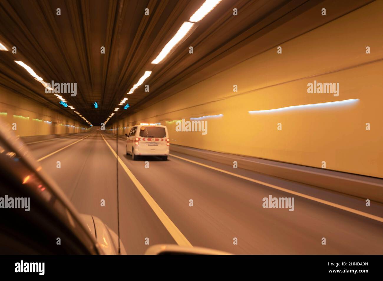 a special car rushes at high speed in a lighted tunnel, bluer, defocus. Stock Photo