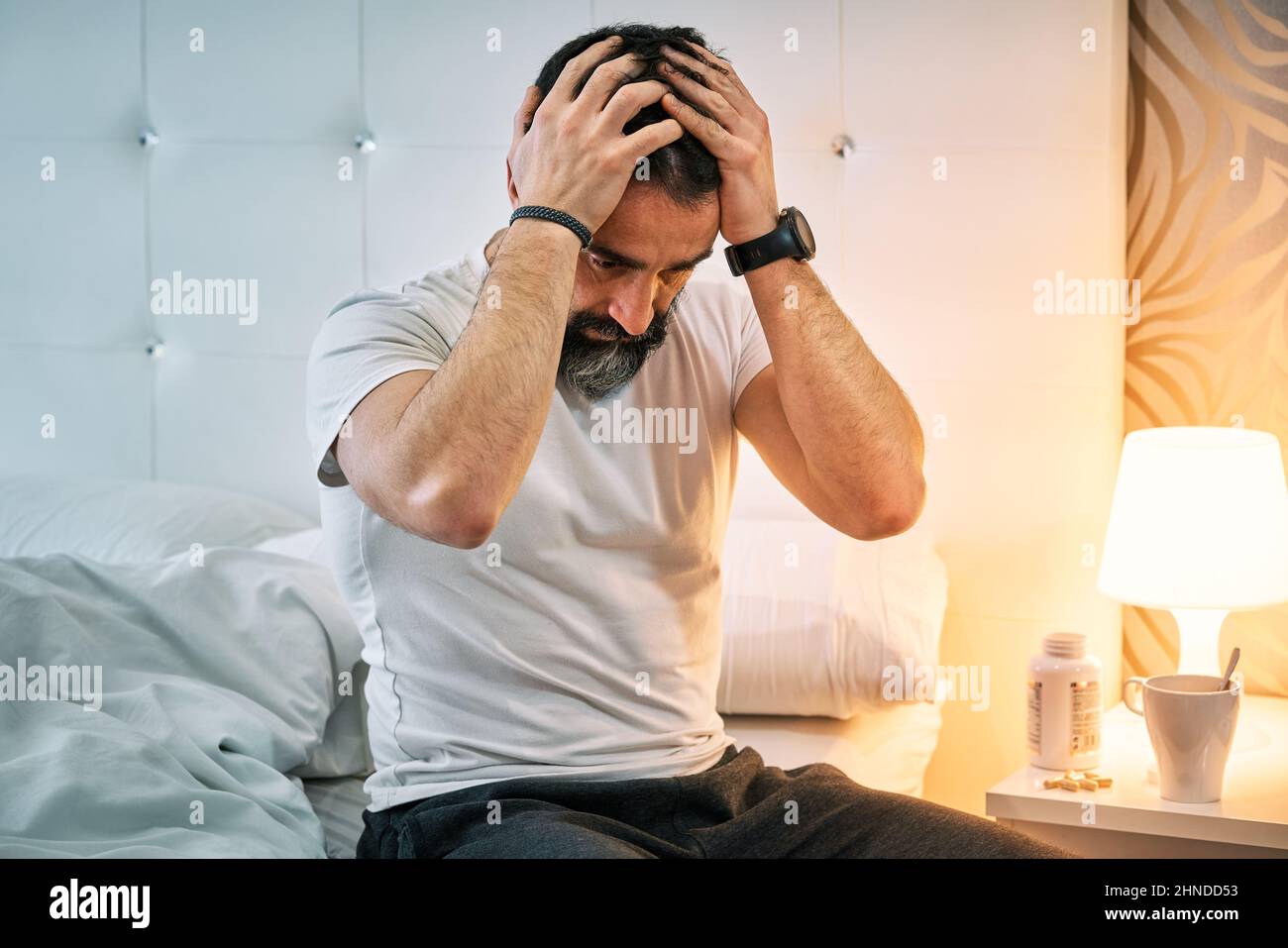 person with some kind of problem sitting on the bed and shaking their