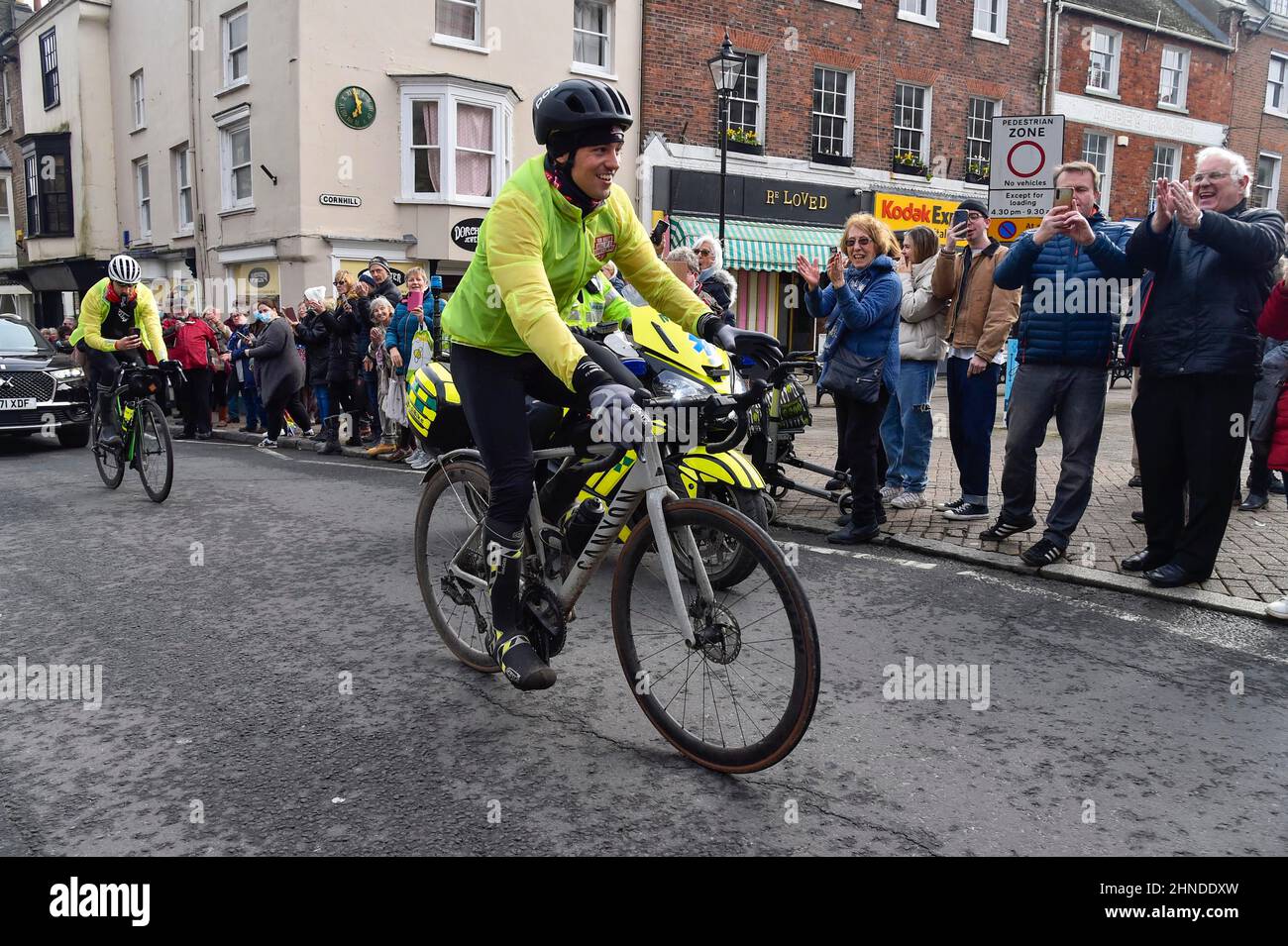 Dorchester, Dorset, UK.  16th February 2022.  Olympic gold medalists Tom Daley OBE is cheered on by people lining the street as he rides through Dorchester in Dorset on day 3 of his Comic Relief Hell of a Homecoming challenge from the Queen Elizabeth Olympic Park in Stratford to his hometown of Plymouth in Devon.  On this leg he is cycling 130 miles from Southampton to Bovey Castle on Dartmoor in Devon.  Picture Credit: Graham Hunt/Alamy Live News Stock Photo