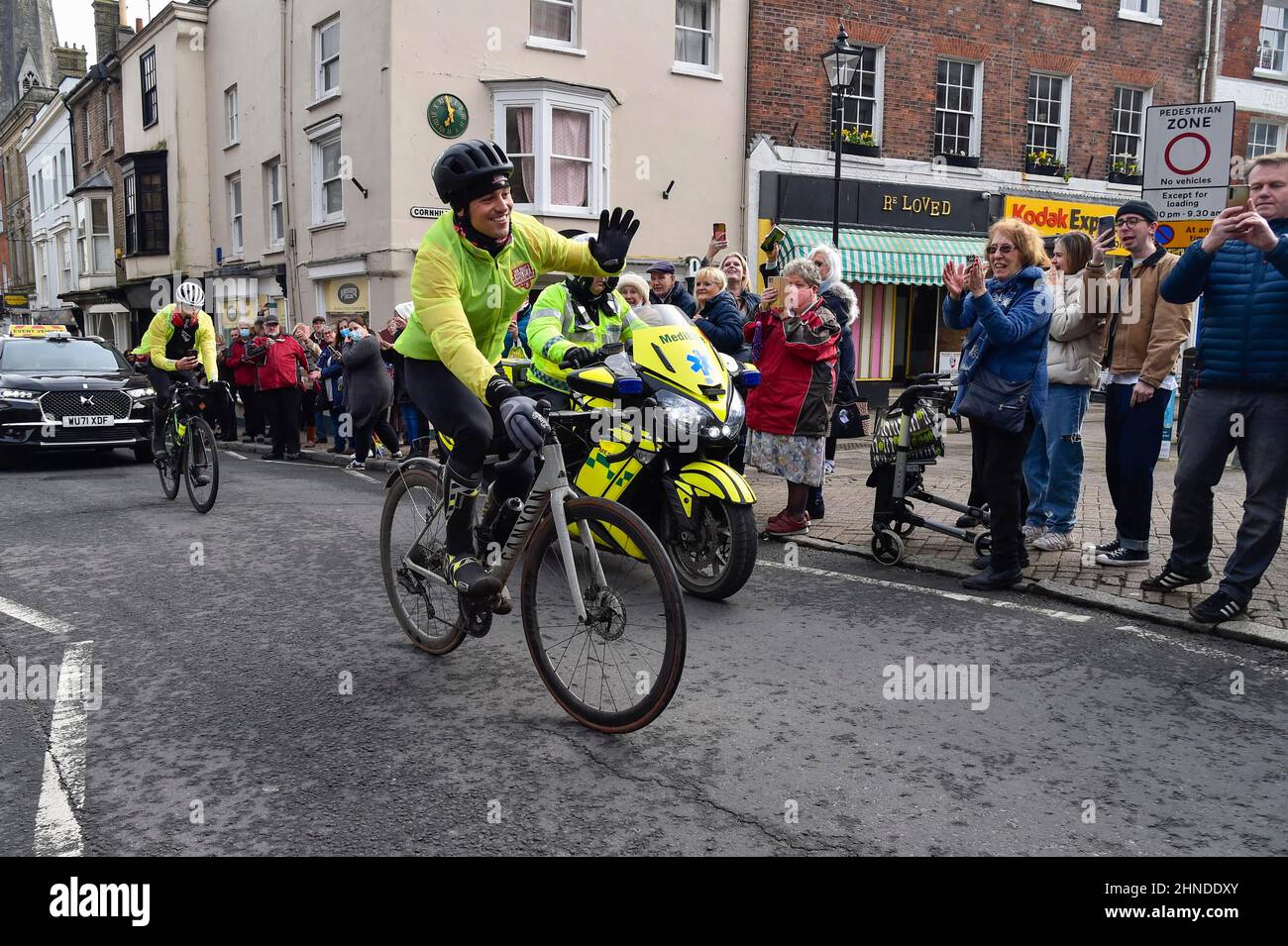 Dorchester, Dorset, UK.  16th February 2022.  Olympic gold medalists Tom Daley OBE is cheered on by people lining the street as he rides through Dorchester in Dorset on day 3 of his Comic Relief Hell of a Homecoming challenge from the Queen Elizabeth Olympic Park in Stratford to his hometown of Plymouth in Devon.  On this leg he is cycling 130 miles from Southampton to Bovey Castle on Dartmoor in Devon.  Picture Credit: Graham Hunt/Alamy Live News Stock Photo