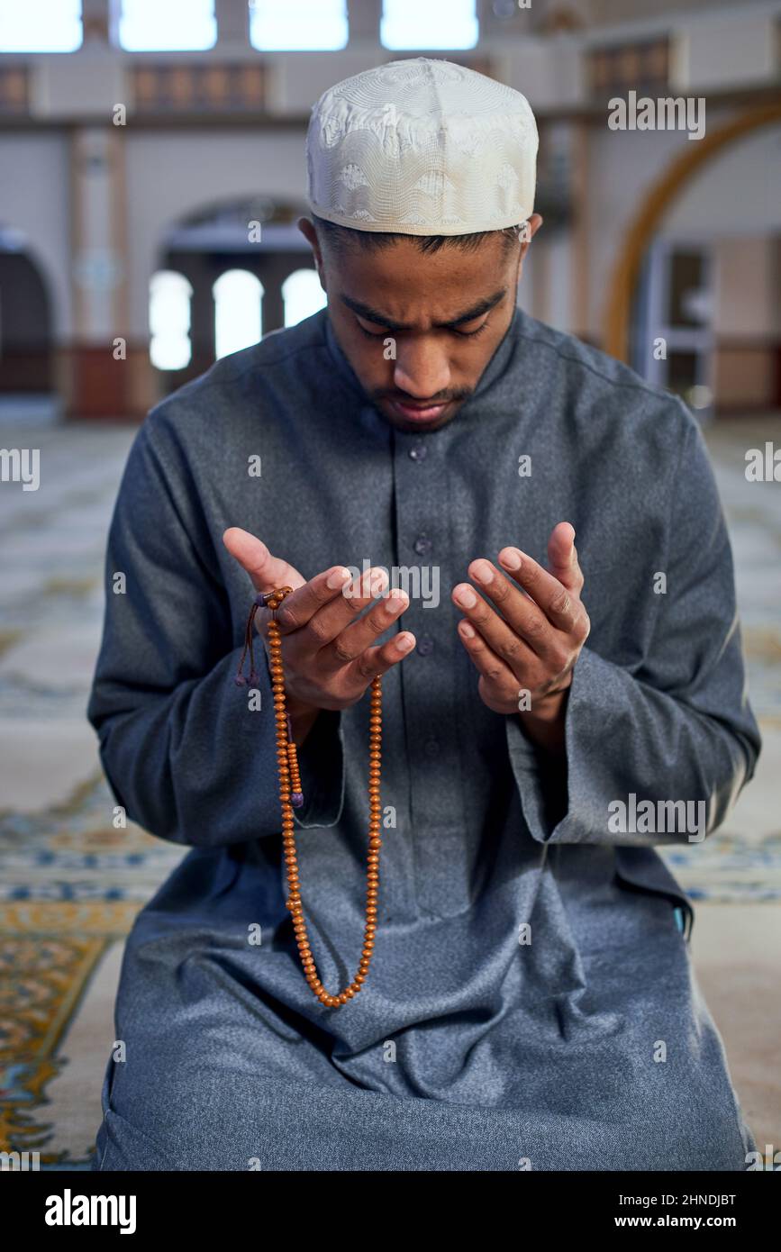 Man praying on his knees hi-res stock photography and images - Alamy