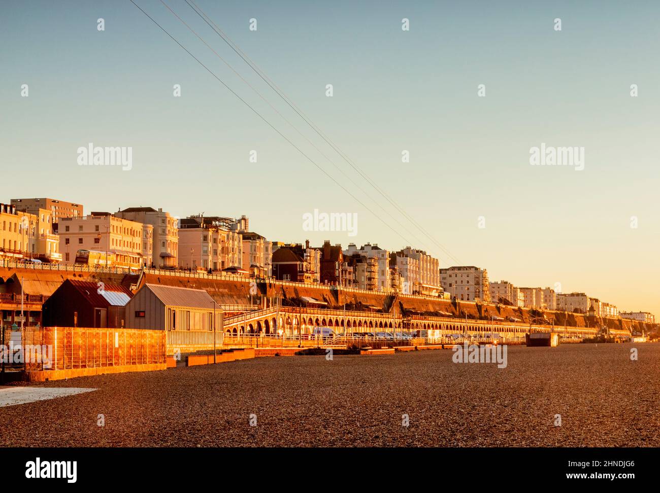 14 January 2022: Brighton, East Sussex, UK - Hotels on the seafront at Brighton, from the beach during winter sunrise. Clear blue sky. Stock Photo