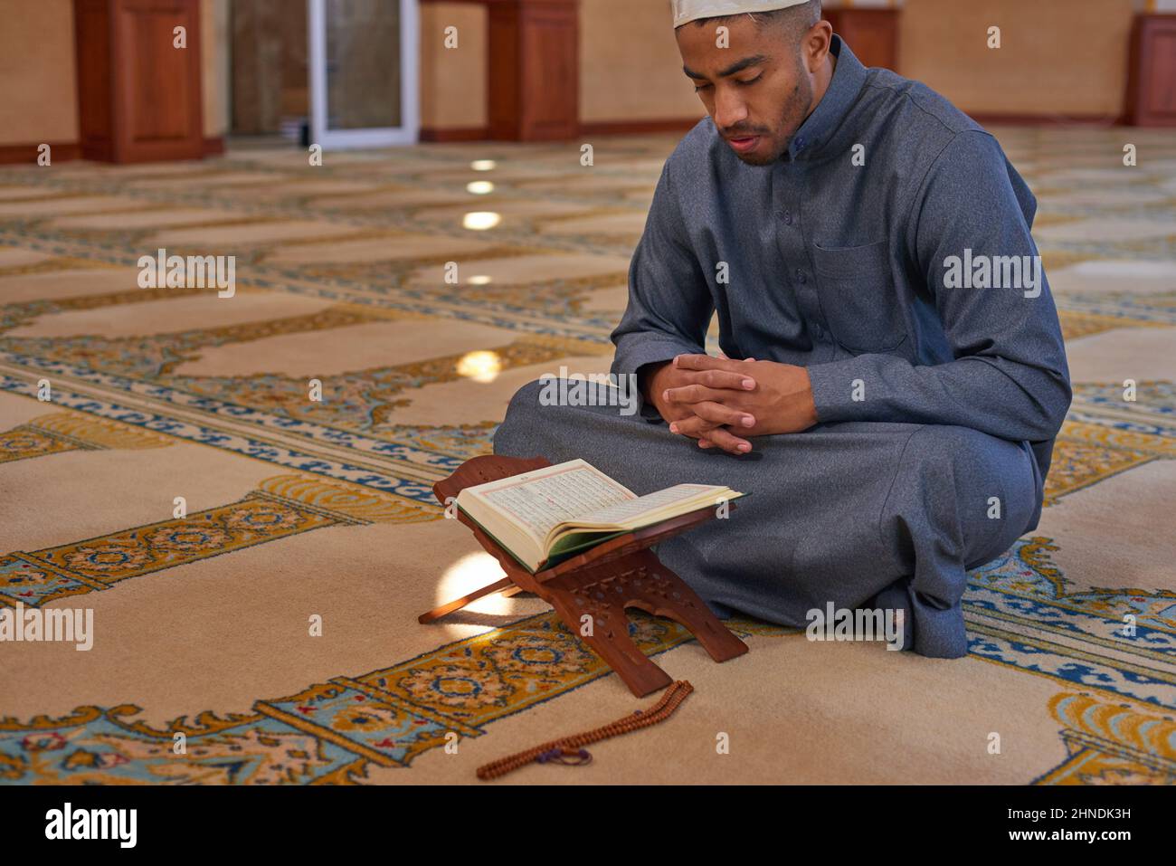 Portrait of a young Muslim male reading the Quran Stock Photo - Alamy
