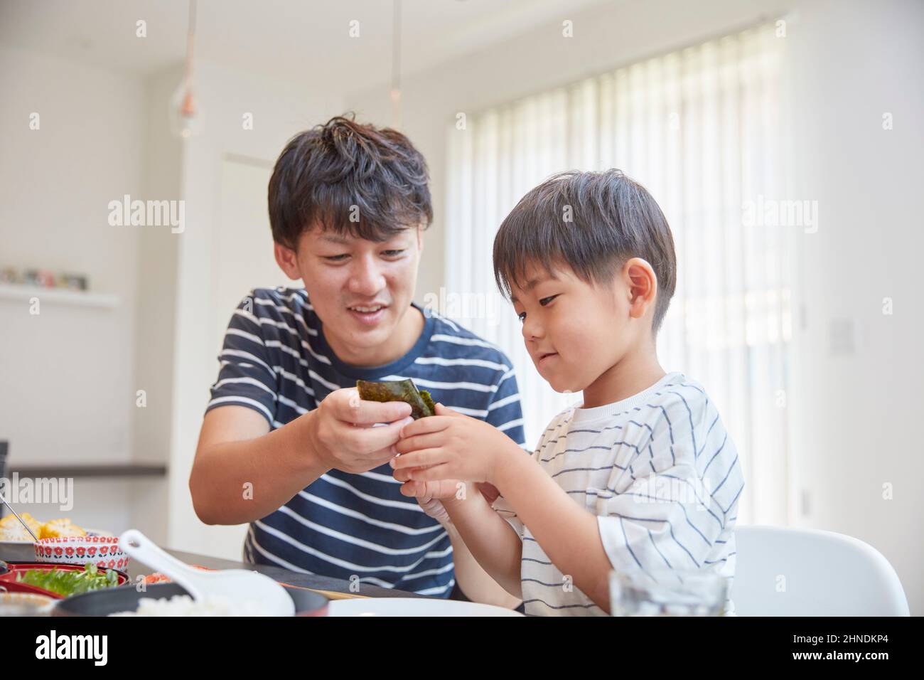 Japanese Father Feeding Rice Stock Photo - Alamy