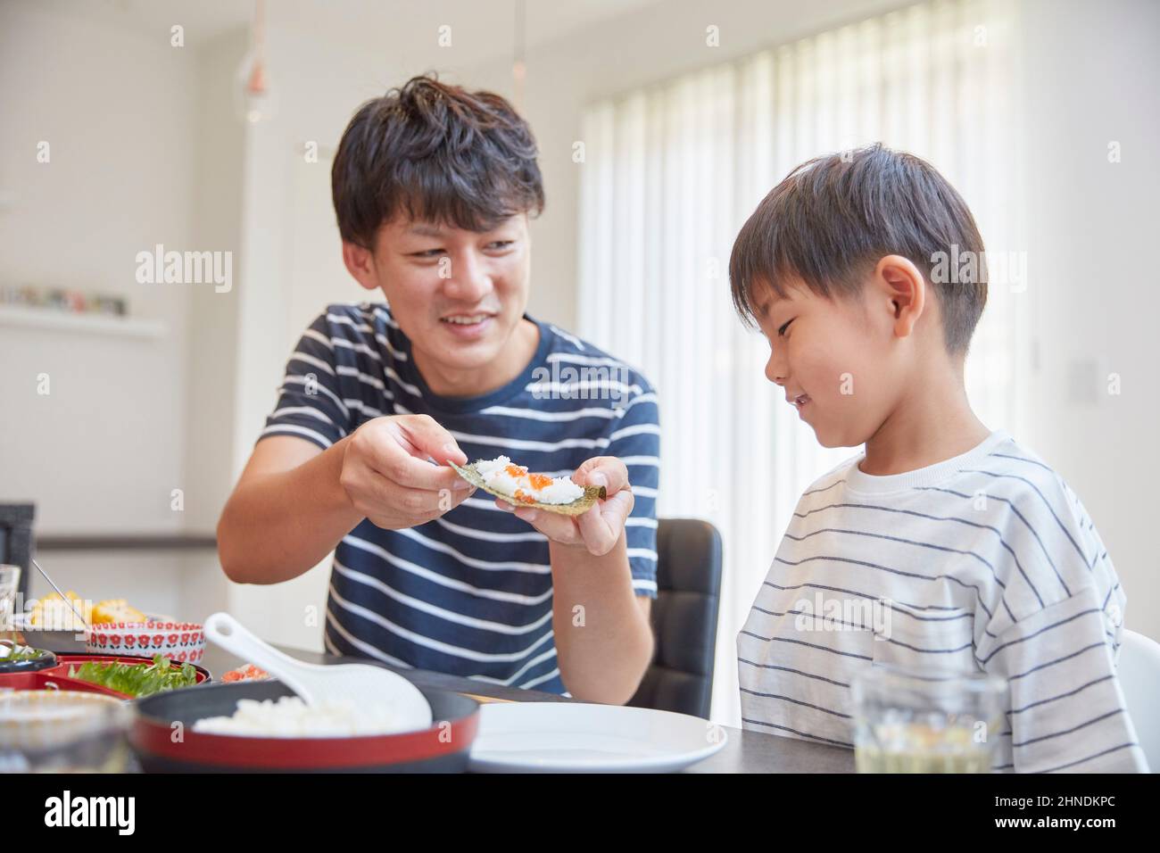 Japanese Father Feeding Rice Stock Photo - Alamy