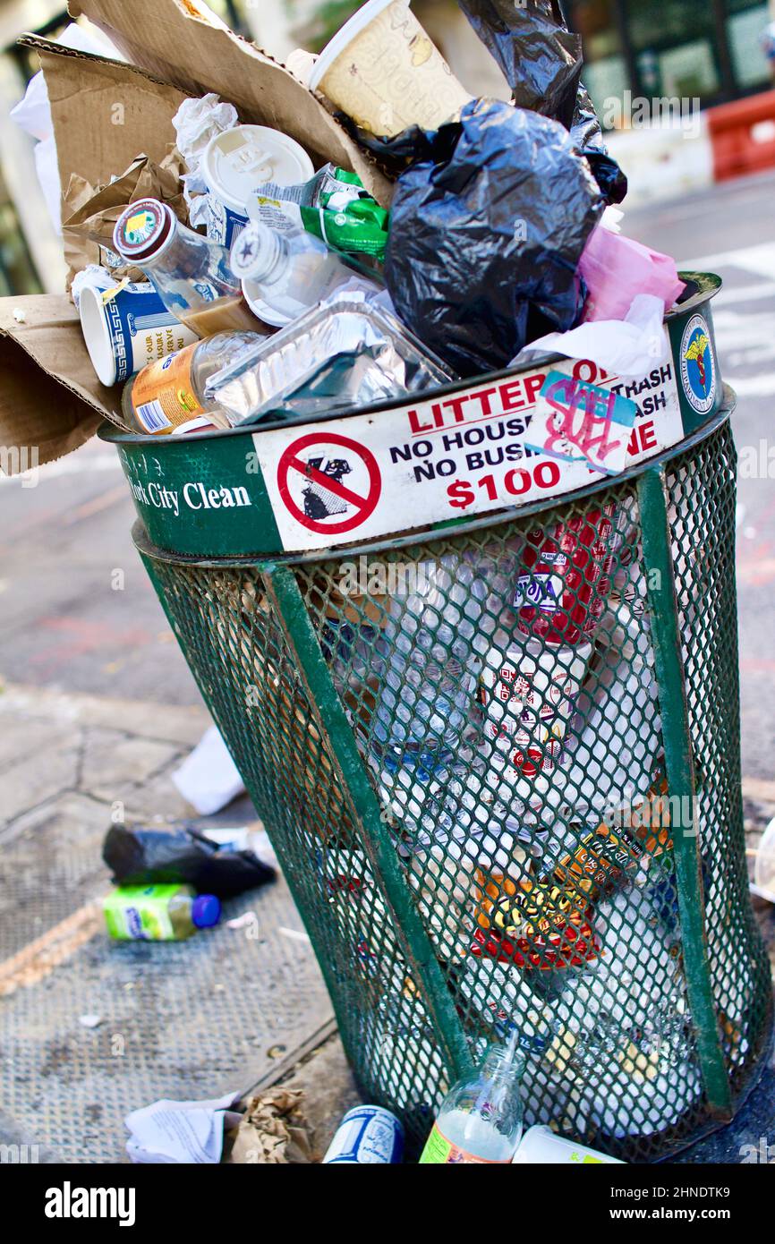 Overflowing Trash can on the street in New York City, USA Stock Photo