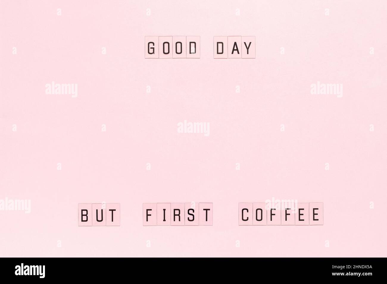 Text Good day, but first coffee on pastel pink paper background. Layout Top view Template for postcard or your design. Stock Photo