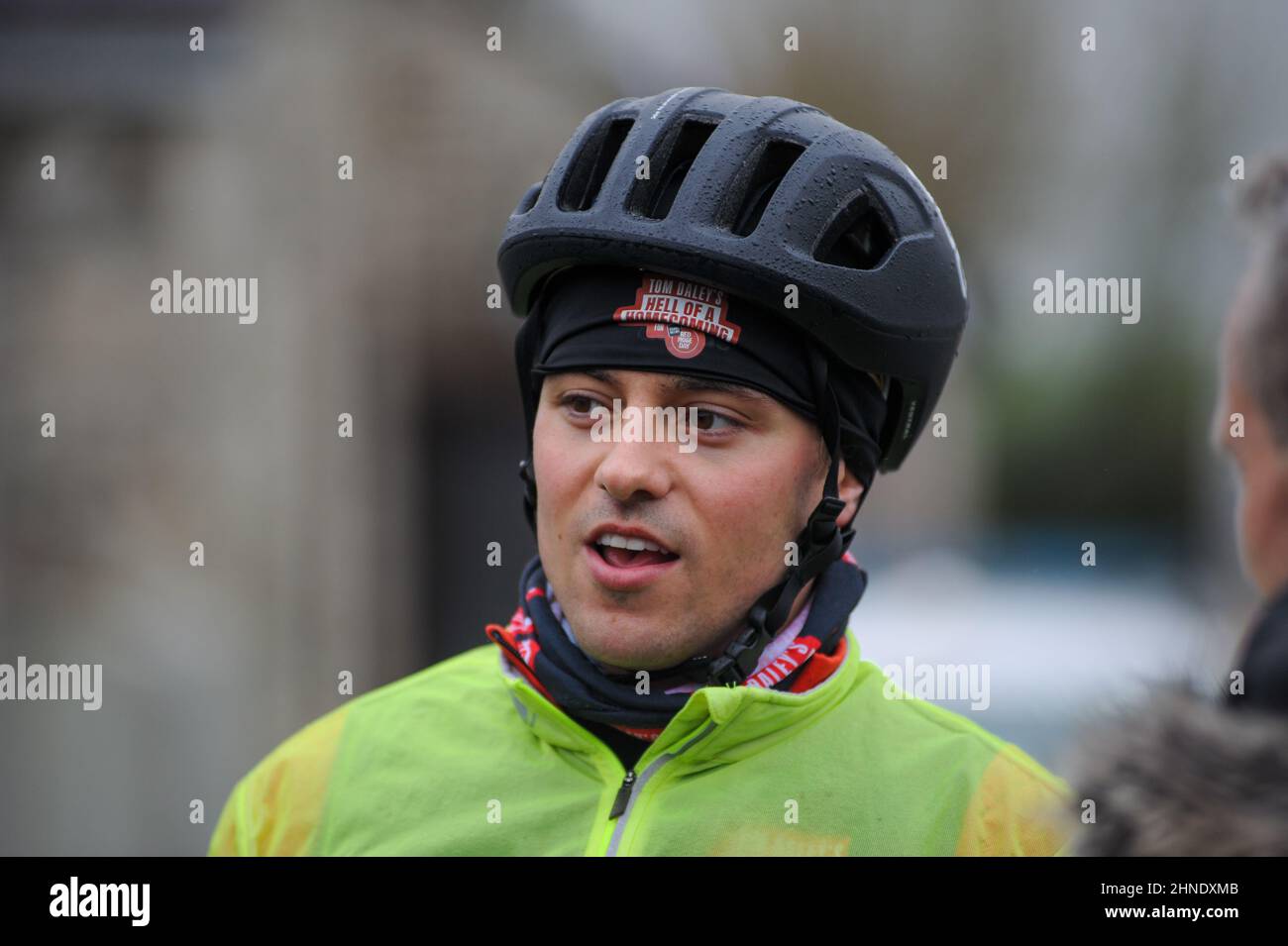 Winterbourne Abbas, Dorset, UK. 16th February 2022. Olympic gold medalists Tom Daley stops for lunch after 7 hours of riding on day 3 of his Comic Relief Hell of a Homecoming Challenge from the Queen Elizabeth Olympic Park in London to his hometown of Plymouth in Devon. On this leg he is cycling 130 miles from Southampton to Bovey Castle on Dartmoor in Devon. Credit: David Partridge / Alamy Live News Stock Photo