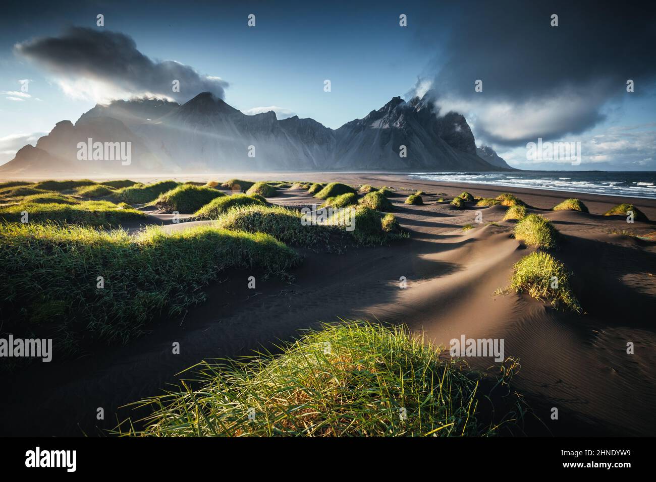 Unique view on the green hills with sand dunes. Location Stokksnes cape, Vestrahorn (Batman Mount), Iceland, Europe. Scenic image of amazing nature ca Stock Photo