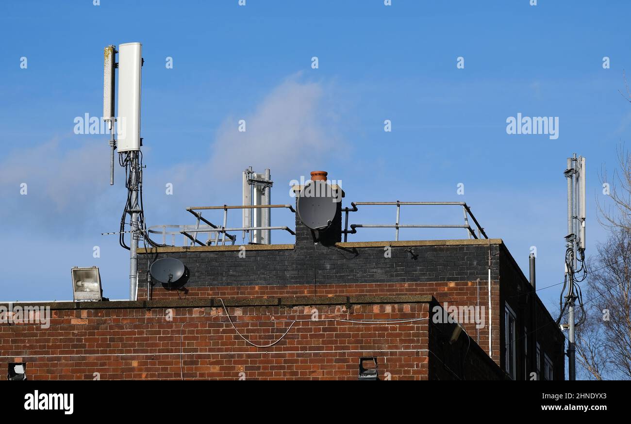 Mobile hone aerials on top of public building. Stock Photo
