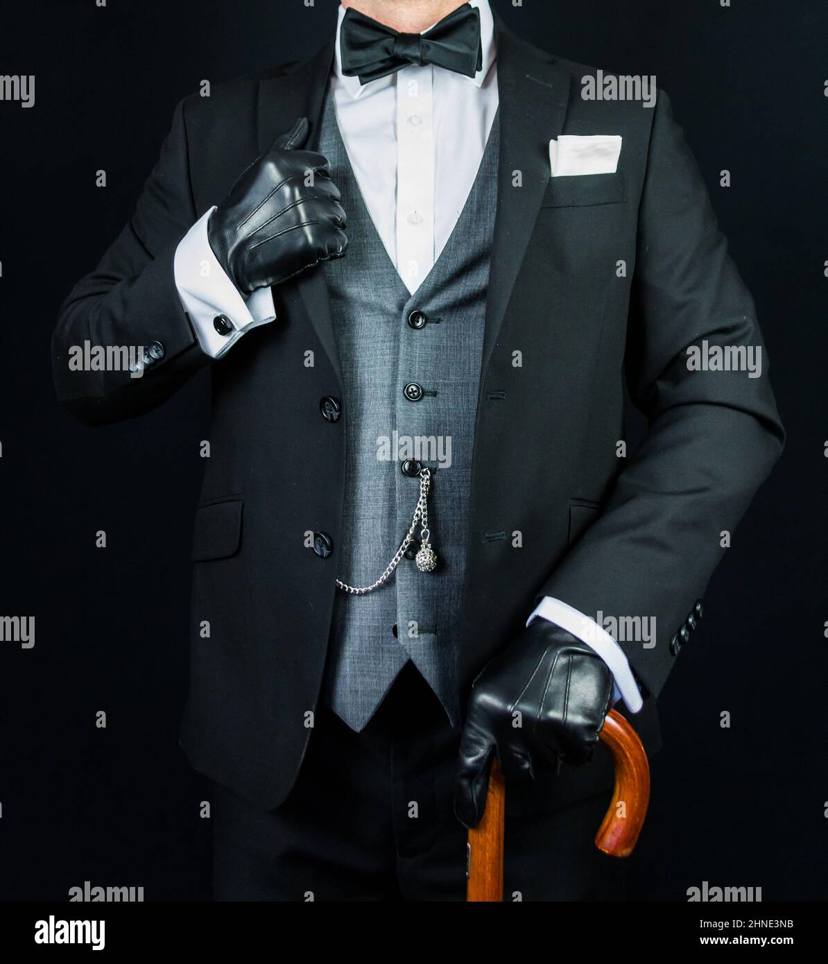 Elegant Gentleman in Dark Suit and Black Leather Gloves Holding Umbrella. Vintage Style and Retro Fashion. Stock Photo
