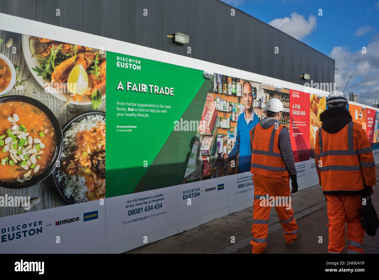 Workers by gates to HS2 fast rail link works at Euston station in