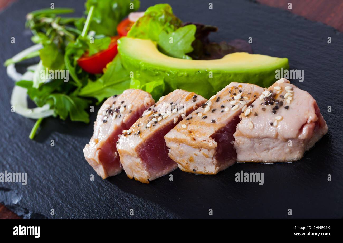Tuna tataki with avocado and greens Stock Photo Alamy