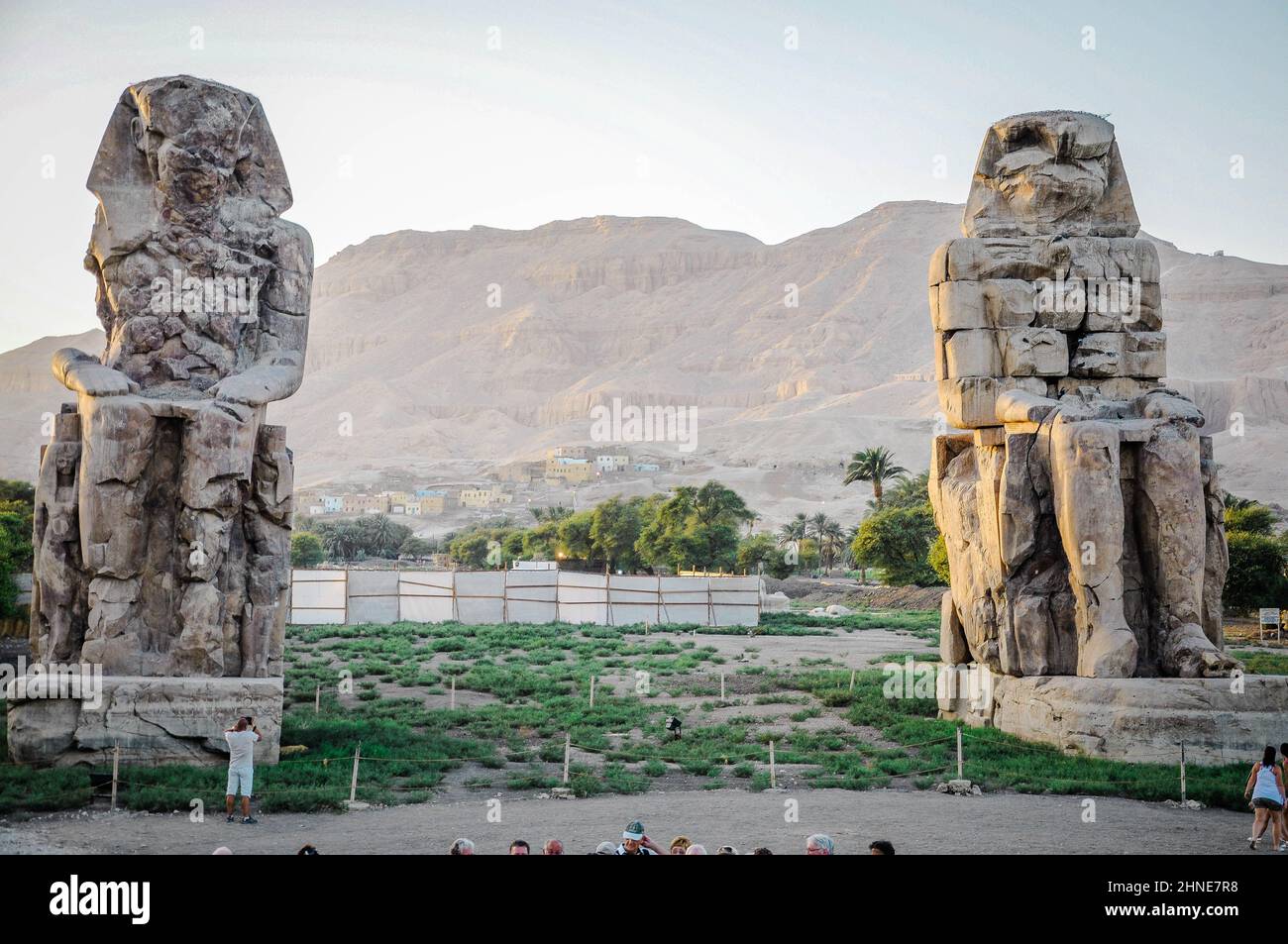 The Colossi of Memnon (also known as el-Colossat or el-Salamat) are two monumental statues representing Amenhotep III (1386-1353 BCE) Stock Photo
