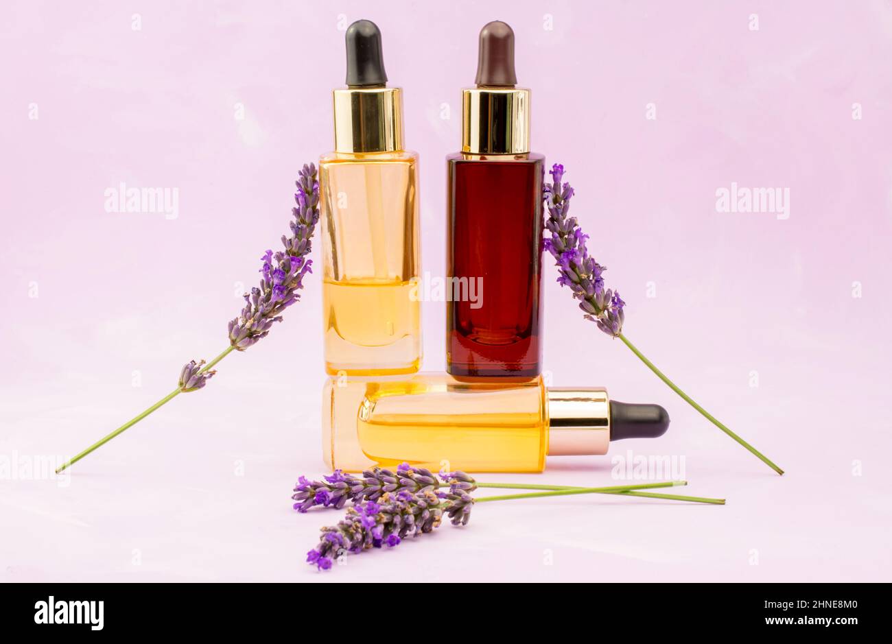 pink background with lavender flowers and oil bottle Stock Photo - Alamy