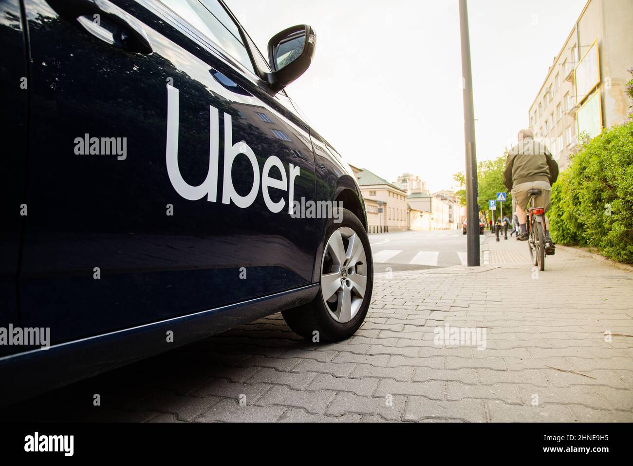 Uber car (Skoda) with inscription on the street before sunset waiting for customer Stock Photo