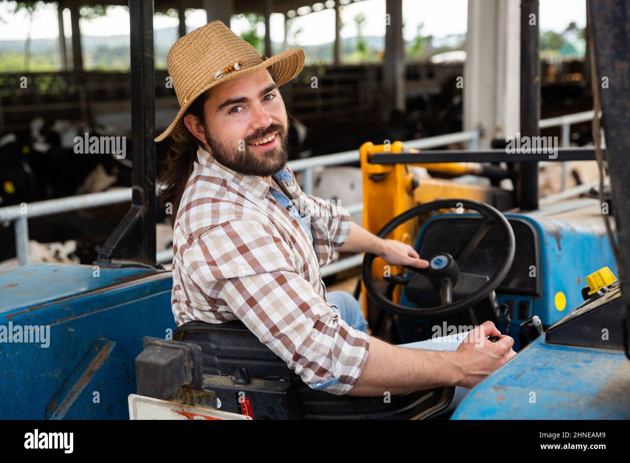 Farmer on farm tractor Stock Photo - Alamy