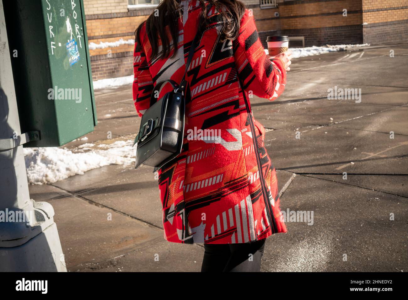 Fashionable woman in colorful winter coat, channeling Russian Constructivism art, in Greenwich Village in New York on Sunday, January 30, 2022.  (© Richard B. Levine) Stock Photo