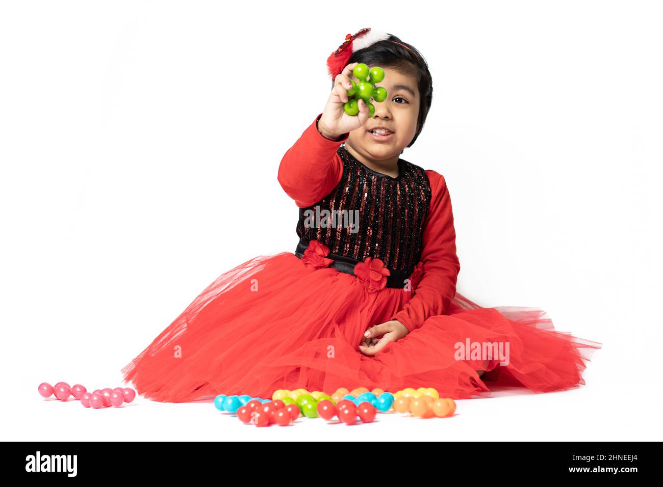 Happy Indian Pretty Girl Playing With Colorful Toys On White Background. Fun, Activity, Educational, Kindergarten, Birthday, Learning, Home Activity, Stock Photo