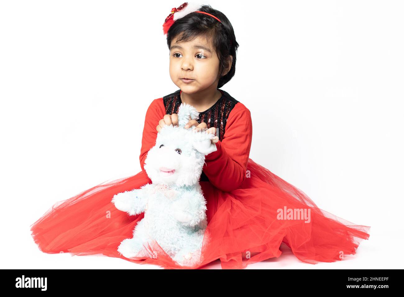Cute Asian Indian Girl Playing With Soft Toy. Isolated On White Background. Fun, Activity, Kindergarten, Birthday, Engagement, Childhood, Leisure Stock Photo