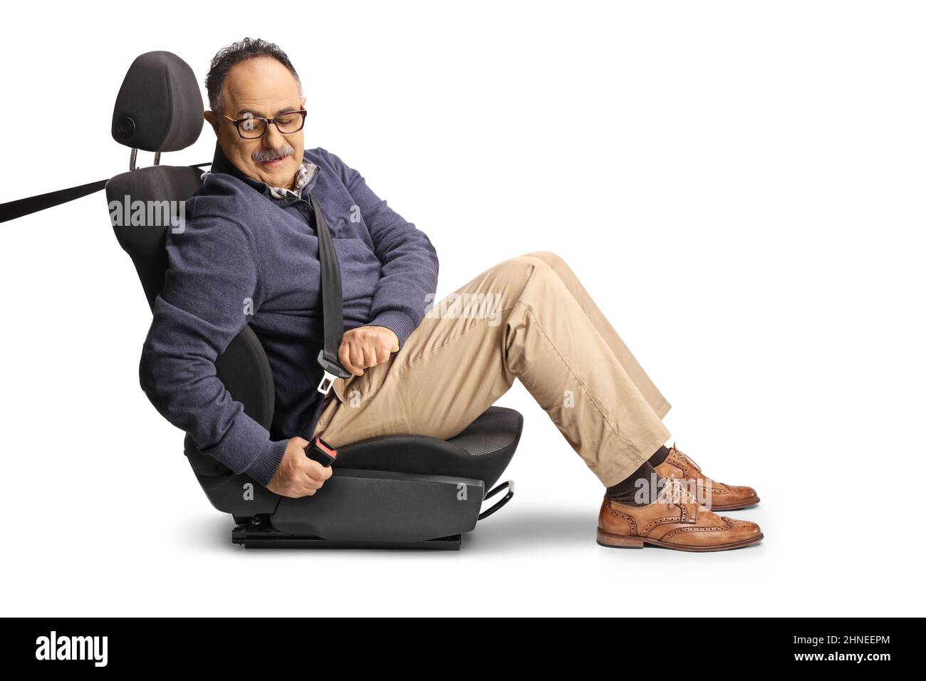 Mature male passenger putting on a seat belt in a car seat isolated on