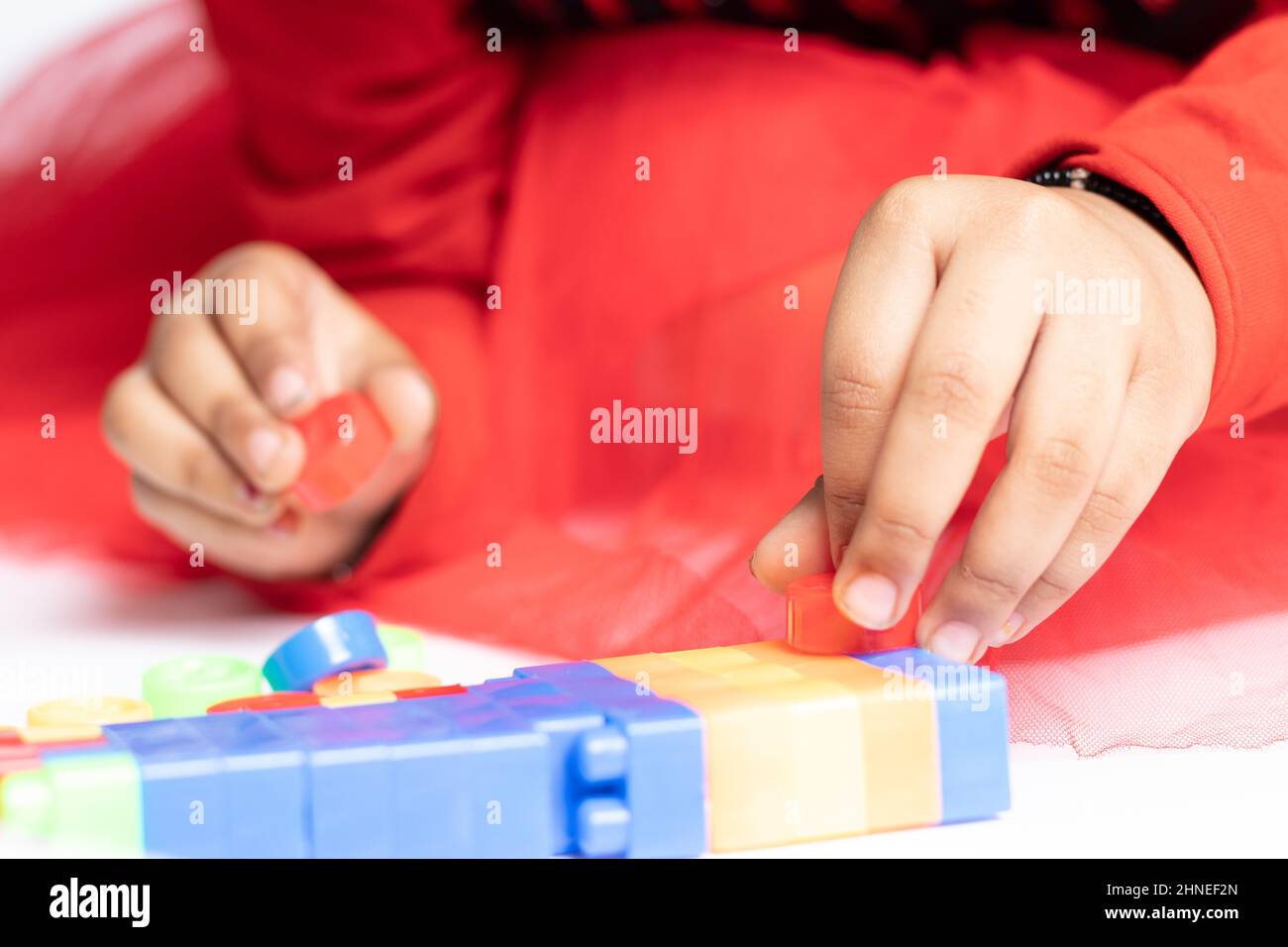 Nimble fingers Of Infant Toddler Kid Playing With Multicolored Building