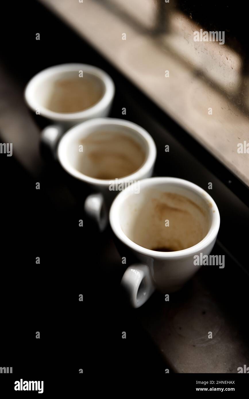 used coffee cups on a windowsill. Winter tones. Stock Photo
