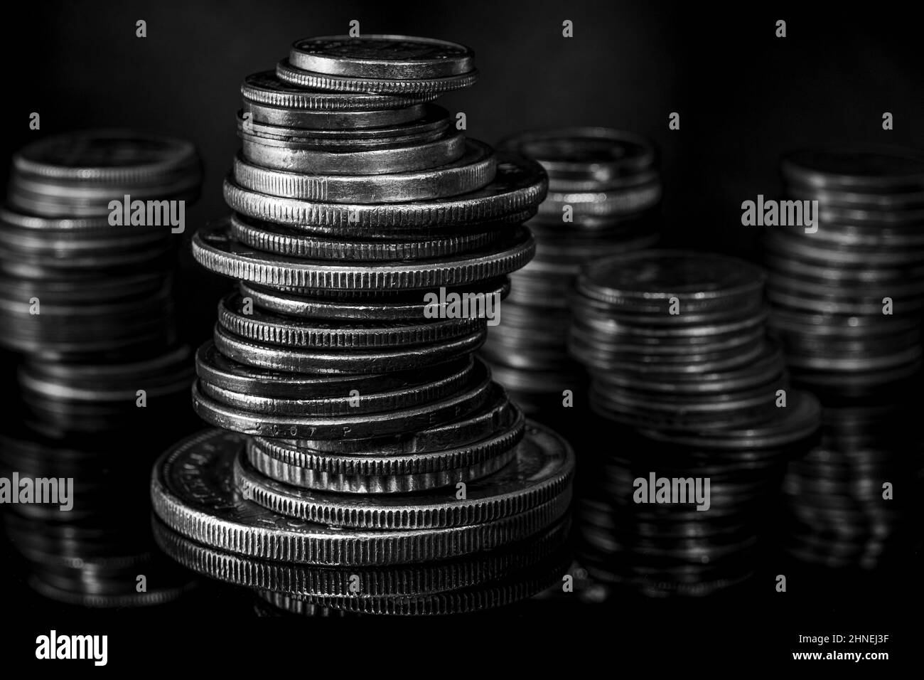 Stacks of Coins Euro Dollar Blurred Background Dramatic Light Black and White Stock Photo