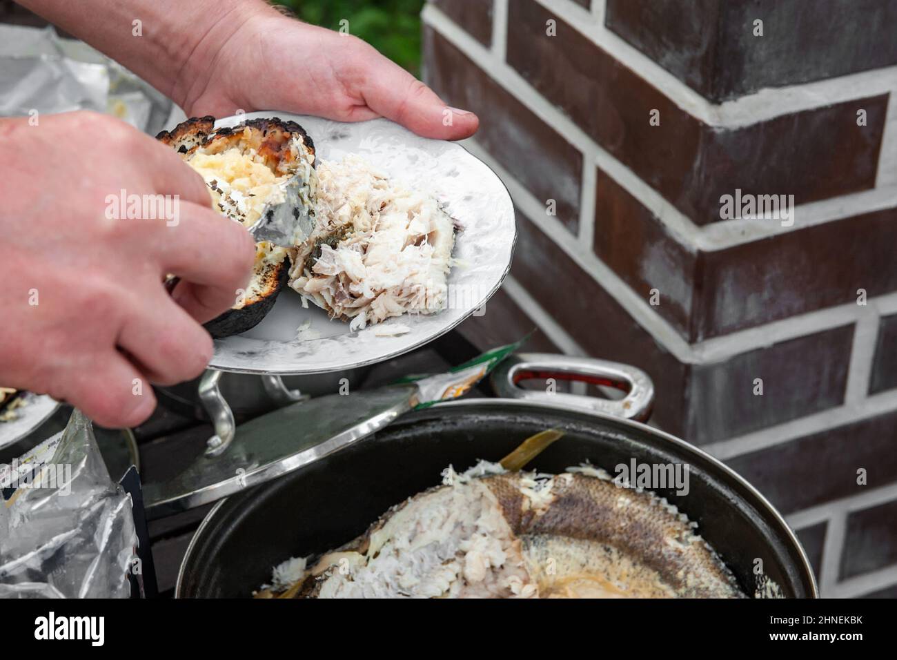 https://c8.alamy.com/comp/2HNEKBK/cooking-white-fish-in-cream-fish-stewed-in-cream-is-prepared-for-a-picnic-in-nature-2HNEKBK.jpg