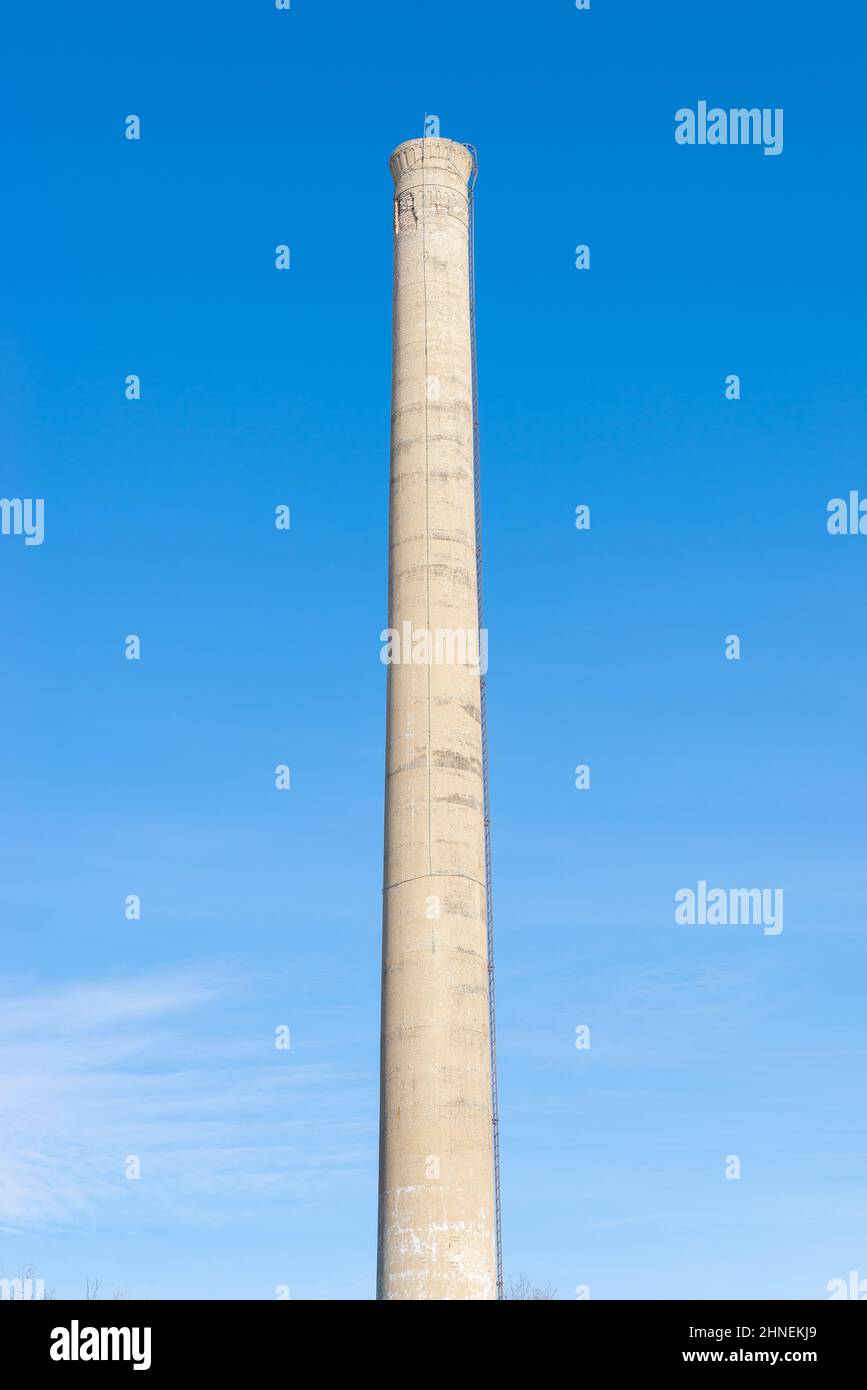 Old smoke stack with blue skies in the background. Stock Photo