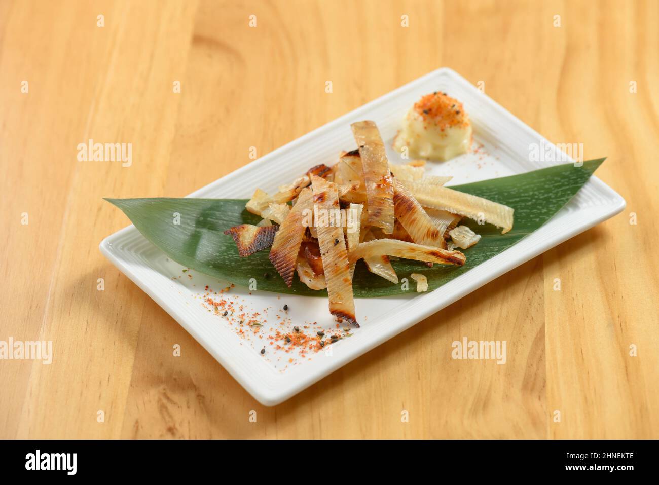 Fried Ei Hire on banana leaf on white tray isolated on wooden background top view Stock Photo