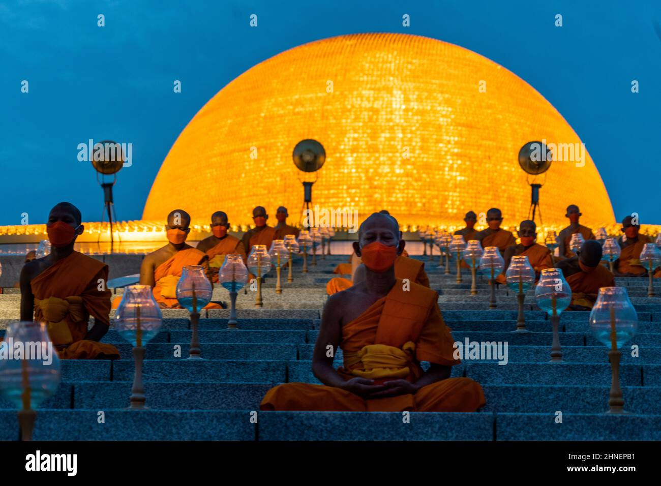 Bangkok, Thailand. 16th Feb, 2022. Monks seen during the meditation ceremony for Makha Bucha Day at Wat Dhammakaya temple.Devotees in person and worldwide marked the temple's 52nd anniversary by lighting 1 million lanterns and planting 1 million trees. (Photo by Matthew Hunt/SOPA Images/Sipa USA) Credit: Sipa USA/Alamy Live News Stock Photo