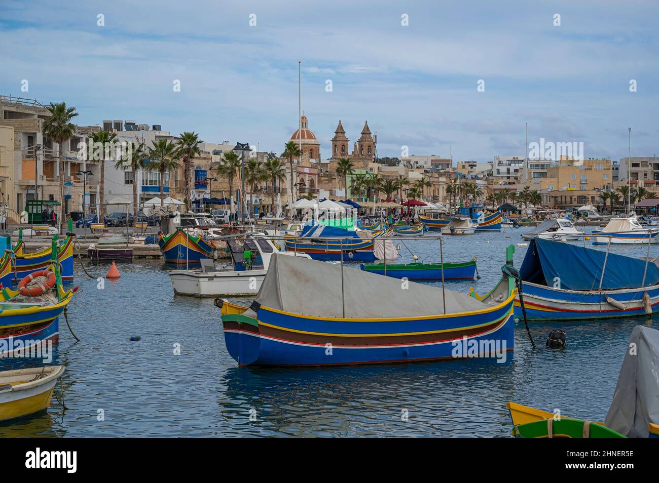 Traditional colorful fishing boats in the harbor of fishing village Marsaxlokk, Malta Stock Photo