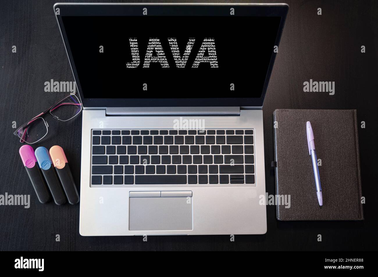 Top view of laptop with text Java. JAVA inscription on laptop screen and keyboard. Learn Java programming language, computer courses, training. Stock Photo