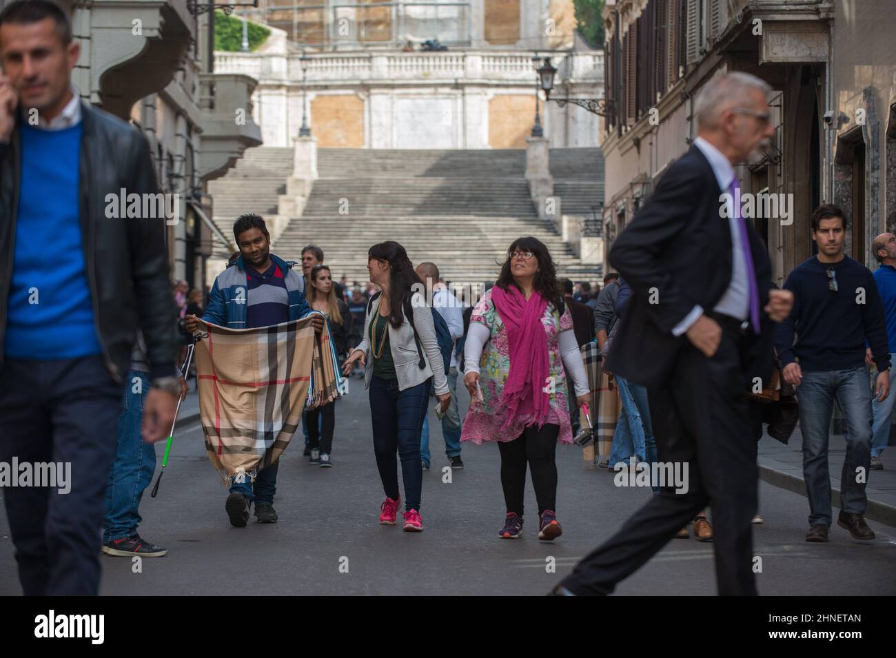 Rome, Italy 10/26/2015: Bangladeshi hawkers try to sell their wares to tourists in Via Condotti, in the background the Spanish Steps. © Andrea Sabbadini Stock Photo