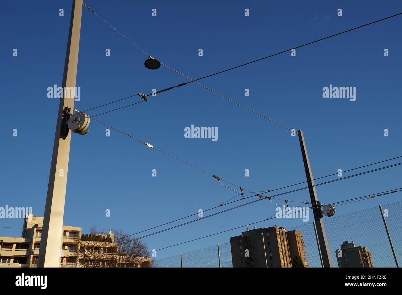 View on automatic tensioning system for tramway which use force of a coil spring to keep constant tension on railway catenary and bearer cables. Stock Photo